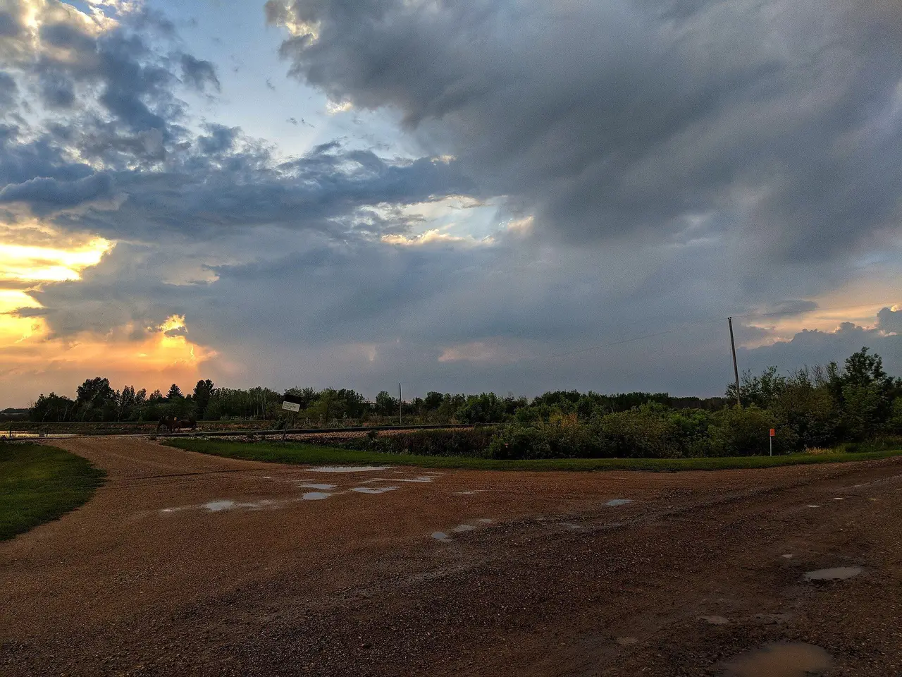 Sunset over a gravel crossing near the tracks, 2018
